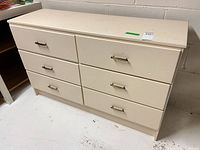 Front view showing six drawers and handles