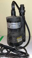 Full view of Mastercraft submersible utility pump with power cord and discharge fitting