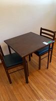 Square wood table with two matching chairs