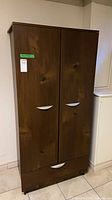 front view of brown pressboard wardrobe