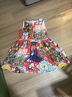 Full view of dress laid flat showing pattern, silhouette, colour