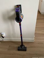 Full view of assembled cordless vacuum standing upright