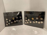 Two Canada 125 coin sets front view showing coats of arms and all coins
