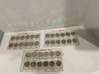 Front view of all three plastic coin holders showing both sets