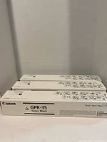Three sealed Canon GPR-35 toner boxes front view