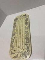 Top view showing full cribbage board surface and wildlife design