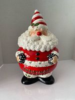 Front view of Santa cookie jar showing ‘CHRISTMAS’ text and overall condition