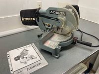 Front view of Delta 36-070C saw with manual
