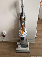 Full view of Dyson DC14 upright vacuum standing against wall