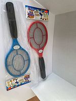 Front view of two packaged electric fly swatter rackets, blue and red