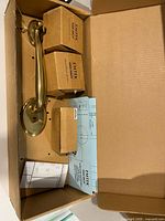 Box contents showing pull handle, small component boxes, paperwork