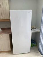 Closed Frigidaire upright freezer