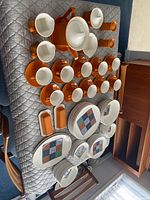 Full layout of orange and white ironstone dinner and tea service pieces on table