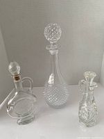 Front view of all three decanters showing shapes, patterns and stoppers