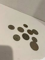 Nine British coins laid out on flat surface