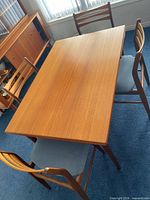 Rectangular teak table with four chairs around