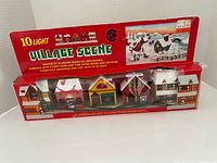 Front of boxed 10-Light Village Scene showing houses and branding
