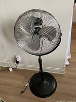Full view of Penguin pedestal fan on floor