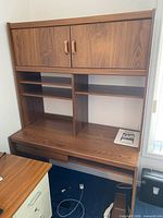 Full view of Sauder desk with hutch showing cabinet doors, shelves, keyboard tray, drawer