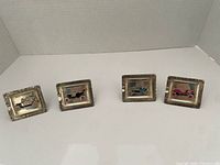 Front view showing all four silver-tone miniature frames with car images