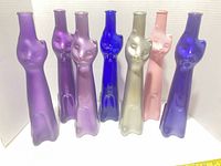Front view of all seven cat-shaped bottles lined up showing colour range and overall condition