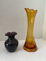 Tall amber vase and small amethyst vase side by side