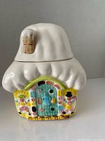 Front view of snow-topped cottage cookie jar