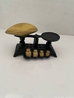 Front view of scale showing both pans and four weights