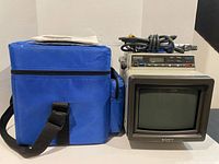 Monitor with blue carry bag, power cord and manual