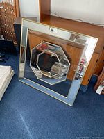 Front view showing square mirror, octagon inset and brass frame