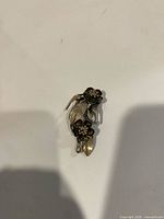 Front view of sterling silver brooch showing floral design