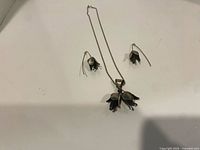 Necklace and both earrings laid out