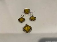 Full set showing ring, two earrings, pendant