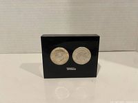 Front view showing both Kennedy half dollars within acrylic block