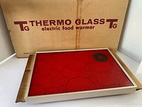 Top view showing red glass surface, frame, box
