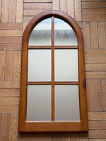 Full view of arched pine framed mirror showing four-pane design