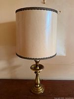 Full view of brass lamp with shade