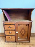 Front view showing drawers, door, open shelf, scale book