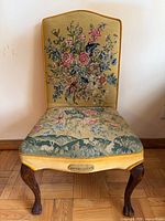 Front view of needlepoint chair showing seat, back and legs