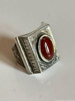 Front view showing engraved rectangular face and carnelian cabochon