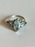 Top view of sterling silver ring showing marquise center and two pear side stones