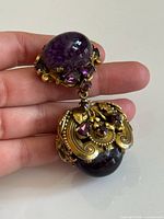 Front view showing purple cabochons and rhinestones