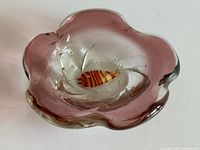 Top angle of purple gradient glass bowl displaying internal goldfish and flared rim
