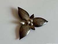 Front view of sterling silver trillium brooch