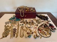 Overall view showing jewelry box and spread of costume jewelry pieces