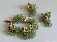 Bracelet and both earrings arranged flat to show overall design and components