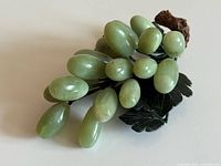 Top view of jade grape cluster showing grapes, leaves, wood stem