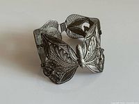 Front view of hinged butterfly filigree bracelet