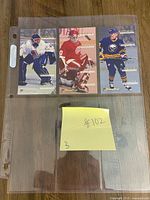 Front view of three Rookie Standouts tall-boy hockey cards in plastic sleeve