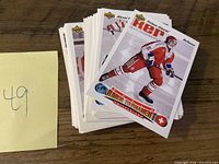 Front view of stacked 1991-92 Upper Deck World Junior Tournament hockey cards; top card shows Swiss player in red uniform